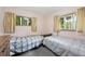 Shared bedroom with two twin beds and natural light from the windows at 8198 E Lehigh Dr, Denver, CO 80237