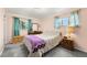 Comfortable bedroom with natural light, dresser, and a cozy aesthetic at 8198 E Lehigh Dr, Denver, CO 80237