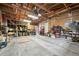 Spacious garage with exposed wooden beams and ample storage, perfect for projects and parking at 8198 E Lehigh Dr, Denver, CO 80237