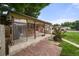 Enclosed brick patio with outdoor furniture, providing a comfortable and private space for relaxation and entertainment at 8198 E Lehigh Dr, Denver, CO 80237