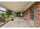 Spacious covered patio, great for outdoor entertaining, with a brick exterior at 8198 E Lehigh Dr, Denver, CO 80237