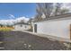 Backyard featuring a detached garage with a concrete patio and landscaping at 4874 S Lincoln St, Englewood, CO 80113