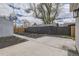 Spacious backyard with a detached garage, concrete patio, and dark wood fence at 4874 S Lincoln St, Englewood, CO 80113