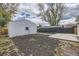 Wide-open backyard with a detached garage, patio, and space for gardening at 4874 S Lincoln St, Englewood, CO 80113