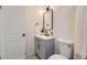Bathroom showing modern vanity, new tilework, toilet, and black hardware at 4874 S Lincoln St, Englewood, CO 80113