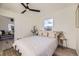 Bedroom featuring hardwood floors, light colored walls, ceiling fan, and large windows at 4874 S Lincoln St, Englewood, CO 80113