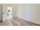 Well-lit bedroom featuring new hardwood floors, neutral paint, and an open door at 4874 S Lincoln St, Englewood, CO 80113
