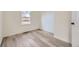 Bright bedroom featuring new hardwood floors, a large window, and neutral paint at 4874 S Lincoln St, Englewood, CO 80113