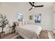 Bedroom featuring large windows, hardwood floors, light colored walls and a ceiling fan at 4874 S Lincoln St, Englewood, CO 80113
