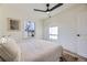 Bedroom with hardwood floors, light colored walls, ceiling fan, and large windows at 4874 S Lincoln St, Englewood, CO 80113