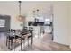 Bright dining area features a dining table, pendant lighting, and an adjacent, open-concept kitchen at 4874 S Lincoln St, Englewood, CO 80113