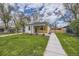 Charming house with well-maintained lawn and sidewalk leading to a cozy front porch at 4874 S Lincoln St, Englewood, CO 80113
