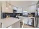 Bright kitchen features quartz countertops, subway tile backsplash, stainless appliances and modern pendant lights at 4874 S Lincoln St, Englewood, CO 80113