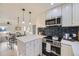 Kitchen shows quartz countertops, subway tile backsplash, stainless appliances and open floorplan at 4874 S Lincoln St, Englewood, CO 80113