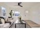 Bright living room features modern furniture, a ceiling fan, hardwood floors, and stylish decor at 4874 S Lincoln St, Englewood, CO 80113