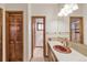 Bathroom featuring wood cabinets, laminate countertop, and shower with glass doors at 103 Red Wing Ct, Mead, CO 80542