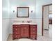 Stylish bathroom featuring a red vanity, decorative mirror, and custom light fixtures at 103 Red Wing Ct, Mead, CO 80542