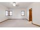 Spacious bedroom with carpet, windows, and a private entrance to the hallway at 103 Red Wing Ct, Mead, CO 80542