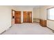 Bright bedroom with built-in desk, large window, neutral walls and carpet at 103 Red Wing Ct, Mead, CO 80542