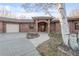 Exterior of the home featuring a brick facade and an arched brick porch at 103 Red Wing Ct, Mead, CO 80542