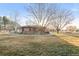 Brick home featuring a circular drive and well maintained lawn and mature trees at 103 Red Wing Ct, Mead, CO 80542