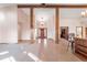 Spacious foyer featuring wood beams, tile flooring, and a view of the front door and adjacent rooms at 103 Red Wing Ct, Mead, CO 80542