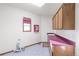 Bright laundry room featuring tile floor, window, cabinets and countertop space at 103 Red Wing Ct, Mead, CO 80542