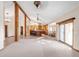 Open-concept living space with wooden beams connecting the kitchen, dining, and living areas at 103 Red Wing Ct, Mead, CO 80542