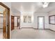 An open living room with carpet, neutral paint, mirrors and a door to the outside at 103 Red Wing Ct, Mead, CO 80542