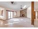 Bright living room featuring a stone fireplace, skylight, and sliding glass door for natural light at 103 Red Wing Ct, Mead, CO 80542