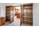 Office space features a wall of built-in shelves and french doors to the kitchen at 103 Red Wing Ct, Mead, CO 80542