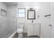 Modern bathroom with white marble walls, shower stall, a new vanity and updated fixtures at 1104 S Biscay St, Aurora, CO 80017