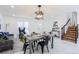 Beautiful dining room with stylish furniture, marble floors, and modern light fixtures at 1104 S Biscay St, Aurora, CO 80017