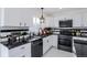 Well-lit kitchen featuring white cabinets, black countertops, and stainless steel appliances at 1104 S Biscay St, Aurora, CO 80017