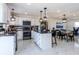 Modern eat-in kitchen with an island, stainless steel appliances, and stylish pendant lighting at 1104 S Biscay St, Aurora, CO 80017