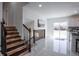 Bright living space with modern staircase, marble floors, and sliding glass doors to let in natural light at 1104 S Biscay St, Aurora, CO 80017