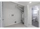 Utility area with water heater, bi-fold doors and view into the renovated bathroom at 1104 S Biscay St, Aurora, CO 80017