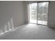Sunlit bedroom with sliding glass doors and vertical blinds at 2215 S Buckley Rd # 201, Aurora, CO 80013