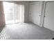 Bedroom featuring neutral carpeting, a bright window, and a large closet with sliding doors at 2215 S Buckley Rd # 201, Aurora, CO 80013