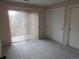 Carpeted bedroom with large windows and closets at 2215 S Buckley Rd # 201, Aurora, CO 80013