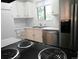 Bright kitchen features stainless steel appliances, white cabinets, subway tile backsplash, new countertops and black oven range at 2215 S Buckley Rd # 201, Aurora, CO 80013