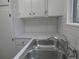 Corner kitchen view with white cabinets, new countertops, stainless steel sink and chrome faucet at 2215 S Buckley Rd # 201, Aurora, CO 80013