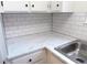 Kitchen featuring new countertops, subway tile backsplash, bright lighting and stainless steel sink at 2215 S Buckley Rd # 201, Aurora, CO 80013
