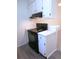 Updated kitchen area with black oven, white cabinets, new countertops, modern backsplash and hardwood-style flooring at 2215 S Buckley Rd # 201, Aurora, CO 80013