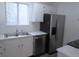 This kitchen has modern stainless steel appliances, white cabinets, and sleek countertops at 2215 S Buckley Rd # 201, Aurora, CO 80013