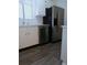 This kitchen features white cabinets, stainless steel appliances, and wood-look floors at 2215 S Buckley Rd # 201, Aurora, CO 80013