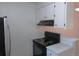 Modern kitchen featuring an updated stove, range hood, and stainless steel refrigerator at 2215 S Buckley Rd # 201, Aurora, CO 80013