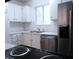 The kitchen has stainless steel appliances, white cabinets, and light countertops at 2215 S Buckley Rd # 201, Aurora, CO 80013