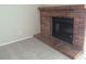 Living room with a classic brick fireplace and neutral carpeting at 2215 S Buckley Rd # 201, Aurora, CO 80013
