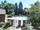 Community swimming pool surrounded by mature trees and a brick fence at 2215 S Buckley Rd # 201, Aurora, CO 80013